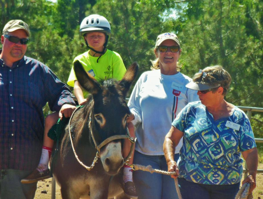 Taren, Frankie and their therapy team walking. Konnie McGruder is far right.
