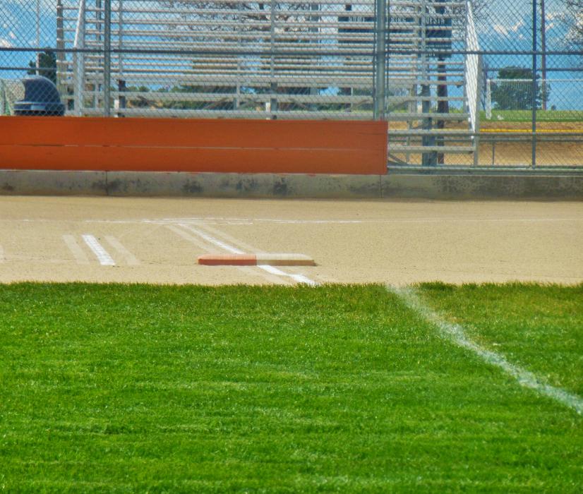 Photo by Brett Fisher. First base line of a softball diamond at the Pete Livermore Sports Complex.