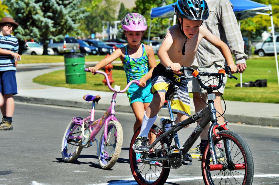 Photo by Brett Fisher. Children climb onto their bikes Saturday morning.
