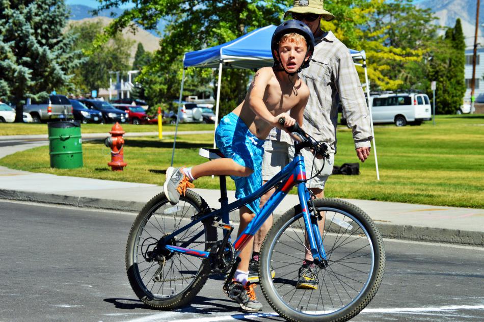 Photo by Brett Fisher. An athlete hurries to climb onto his bike and continue the race.