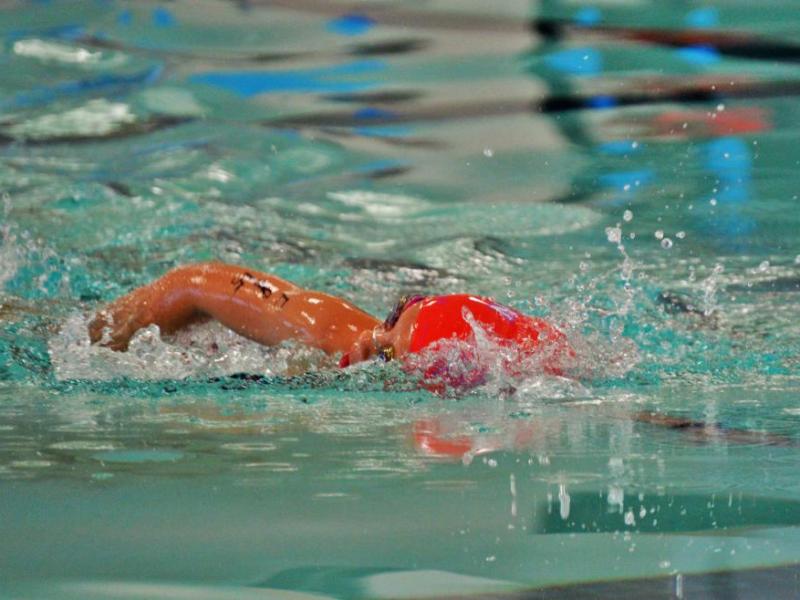 Photo by Brett Fisher. The leader of the 7-8 age group completing her lap in the pool.