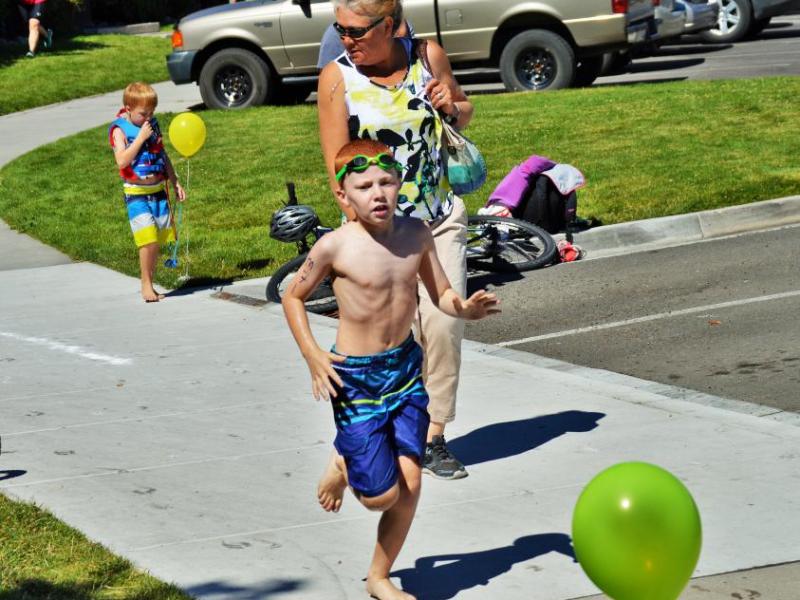Photo by Brett Fisher. A boy hurries to his bicycle after completing his pool lap.