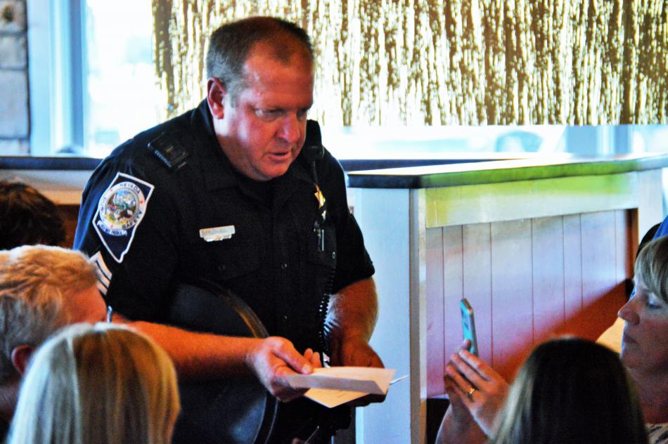 Photo by Brett Fisher. NHP Officer takes an order from customers.