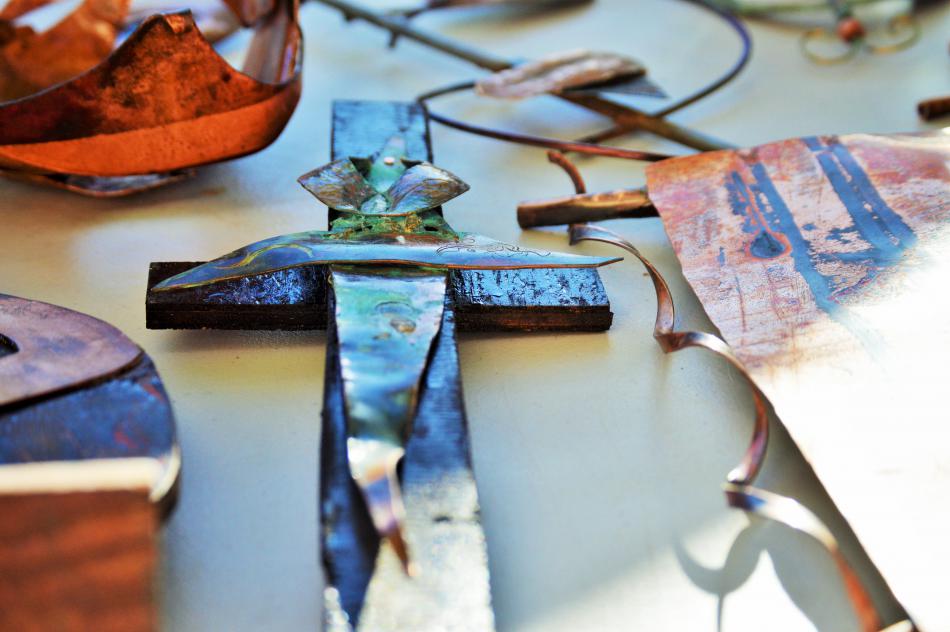 Photo by Brett Fisher. Metal cross sculpture by Jay Foremaster.