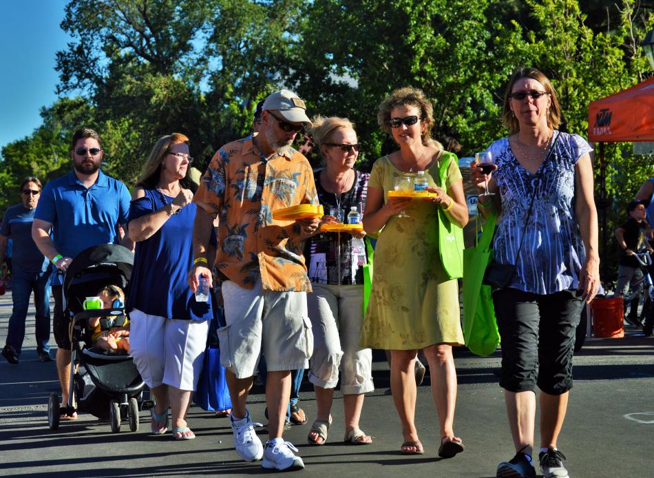 A group walks down Curry Street with their plates Saturday evening.