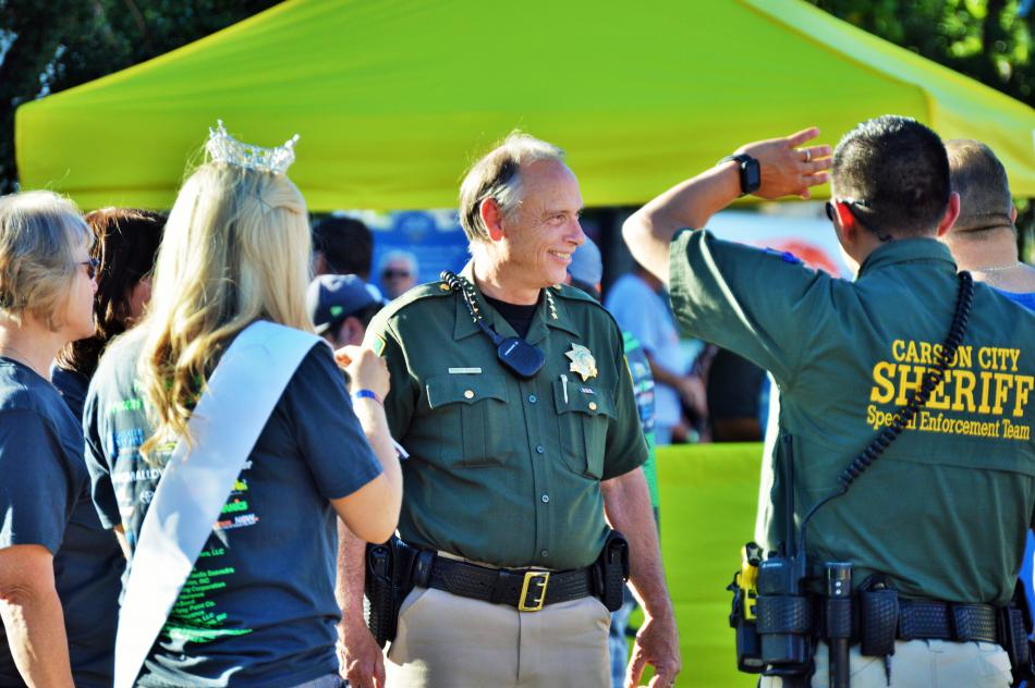 Carson City Sheriff Ken Furlong (center) talks with a deputy and others on Curry Street.