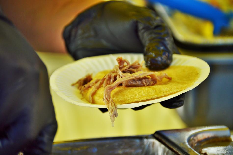 A taco being served up for tasters.