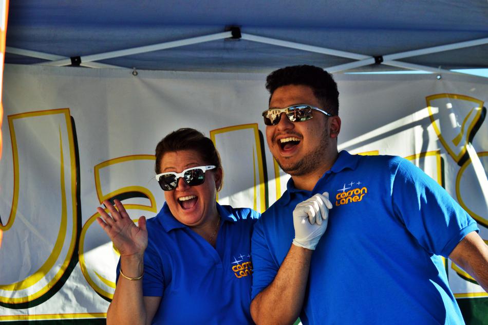 Employees at Carson Lanes and Wally's Pizza and Subs pose in their booth.