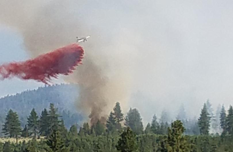 Photo courtesy Carol Wilson. An air tanker drops retardant on the Diamond Fire near Markleeville.