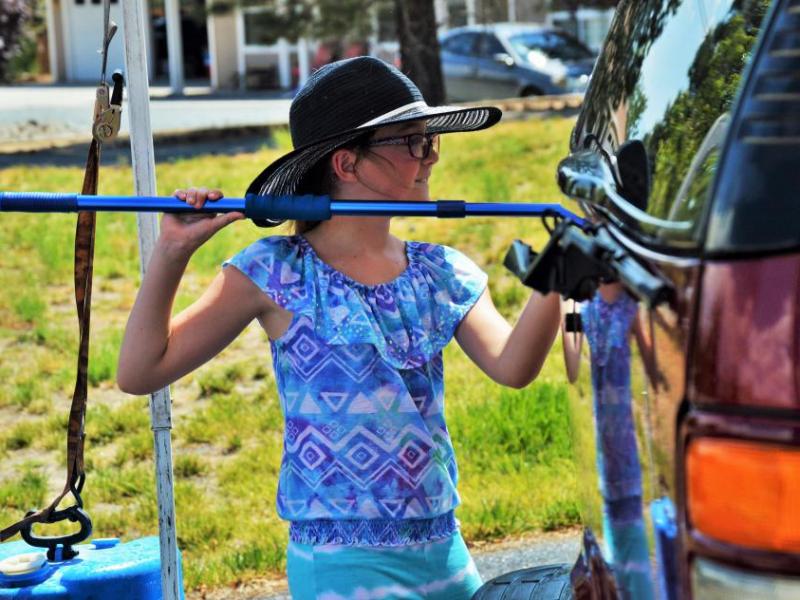 Emma Spears, 8, scrubs an SUV Friday afternoon.