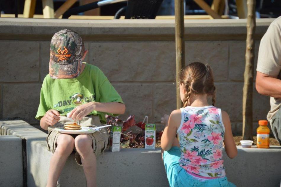 Photo by Lisa Fisher. Children indulge in pancakes Saturday morning at Bob McFadden Plaza.