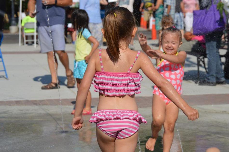Photo by Lisa Fisher. Joy on the face of a child running through water from the splash pad.