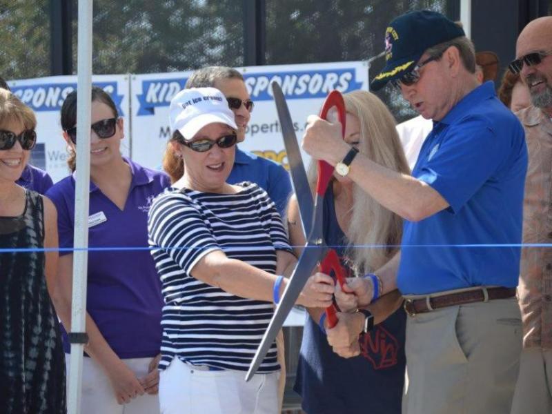 Photo by Lisa Fisher. Mayor Bob Crowell and Jenny Lopiccolo cut the ribbon Saturday morning to open Bob McFadden Plaza.
