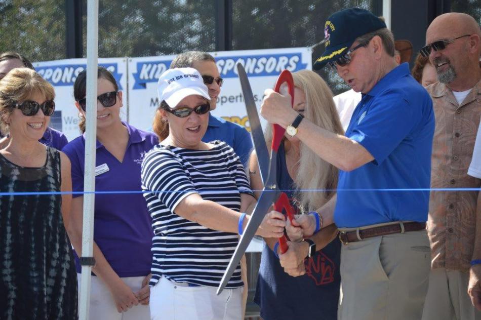Photo by Lisa Fisher. Mayor Bob Crowell and Jenny Lopiccolo cut the ribbon Saturday morning to open Bob McFadden Plaza.