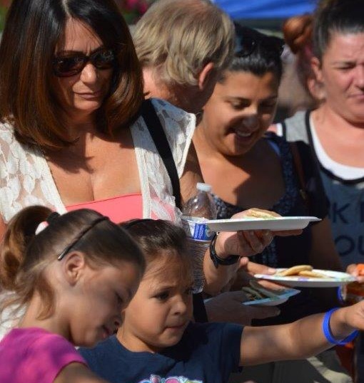 Photo by Lisa Fisher. Families line up Saturday morning for the pancake breakfast at Bob McFadden Plaza.