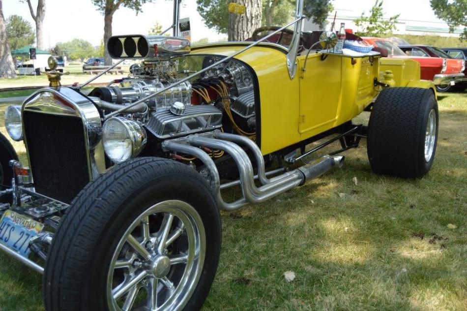 A custom Model A Ford street rod with exposed engine.