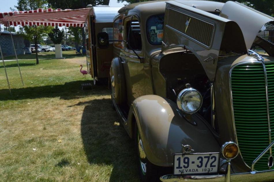 Classic panel wagon with vintage trailer hitched to it.