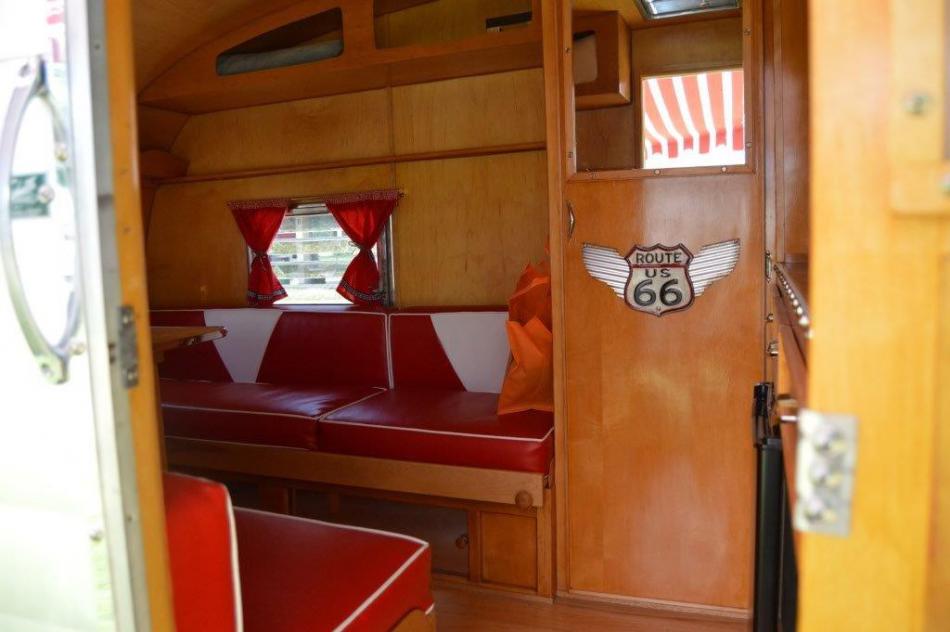 Wooden interior of a vintage camp trailer.