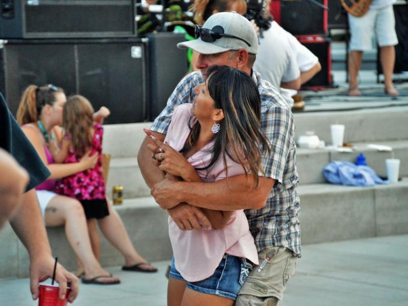 A couple dances close to the live music at Bob McFadden Plaza.