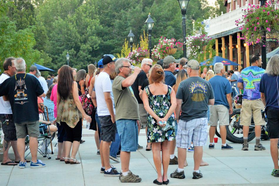 People mingle on Bob McFadden Plaza Saturday night.
