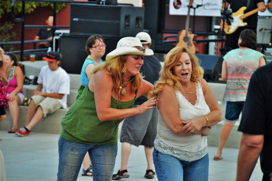 Ladies enjoy the live music on the plaza Saturday night.