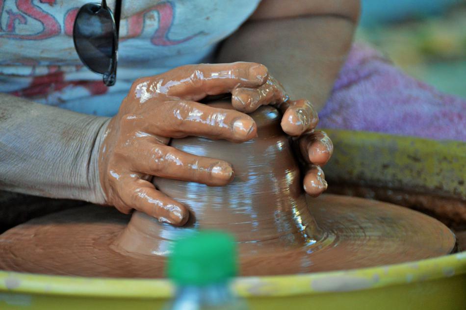 Robin McGregor of Carson CIty Pottery throws clay during July's Community Art Night.