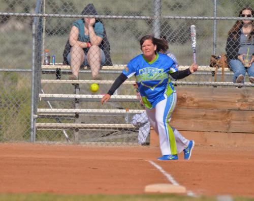 A batter slaps a base hit during the AWS Midnight Madness softball tournament over Memorial Day weekend.