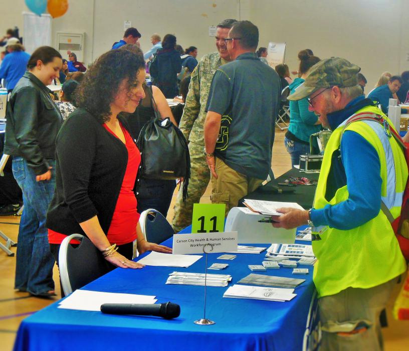Ana Gregg (left) of the Carson City Workforce Program speaks with a job seeker at the February 2016 job fair.