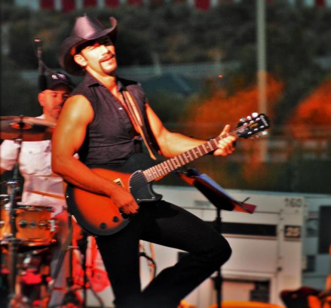 Photo by Brett Fisher. Adam D. Tucker as Tim McGraw.