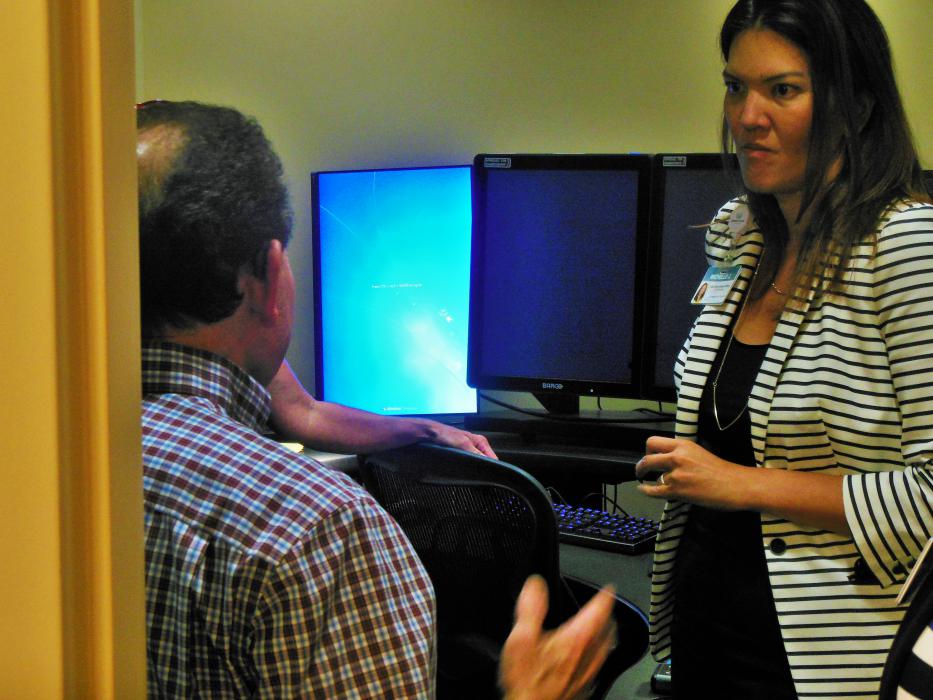 Carson Tahoe COO Michelle Joy talks to guests inside a radiologist's control room.