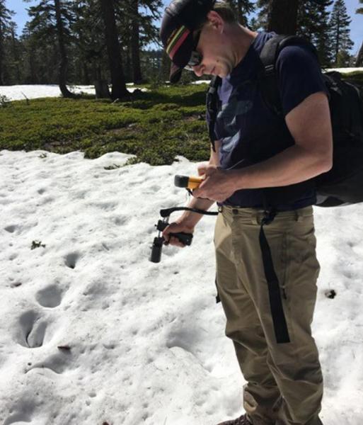 UNR Ecohydrologist Adrian Harpold takes measurements of the Sierra Nevada mountain snowpack.