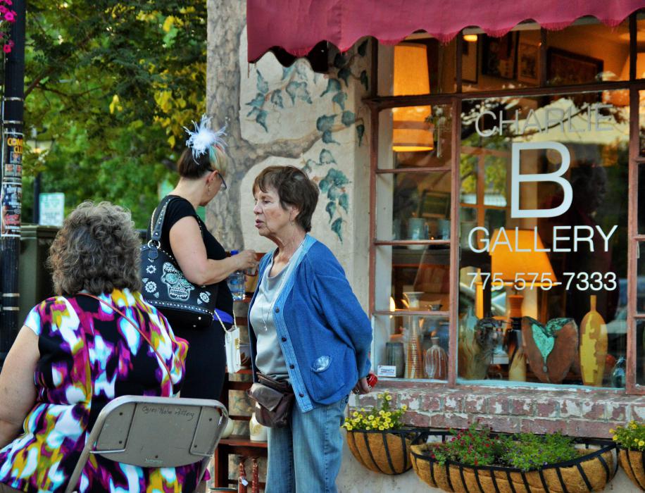 Visitors check out art displays in front of the Charlie B. Gallery.