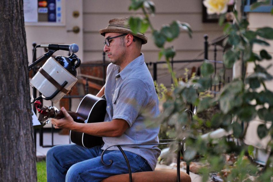 A musician entertains at Telegraph Square Thursday night.