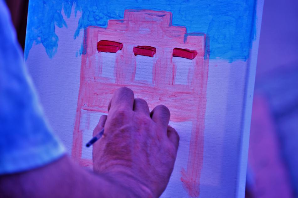 An acrylics painter works on a painting Thursday night at Telegraph Square.