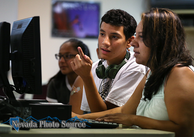 Maria Beltran helps her son Ricardo Haro, 17, register online for classes. Photo by Cathleen Allison, Nevada Photo Source