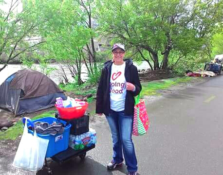 Photo courtesy Faith Hope Love. Cassidy Davis delivers donations to a homeless camp along the Truckee River.