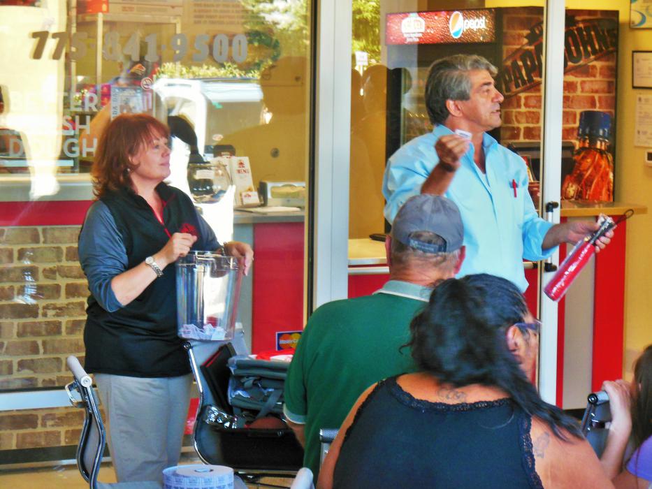 Susan (left) and Michael Kubrich drawing raffle tickets for prizes Wednesday at Papa John's in Carson City.