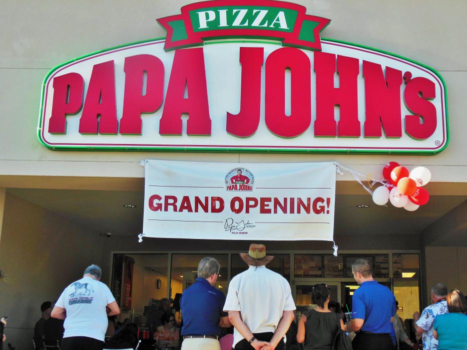 Visitors gather and mingle out in front of the new Papa John's Pizza in Carson City.