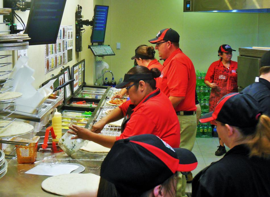 Team members hard at work making pizzas at Papa John's Wednesday afternoon.