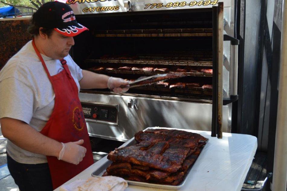 Dozens of St. Louis style rib racks fresh out of the cooker.