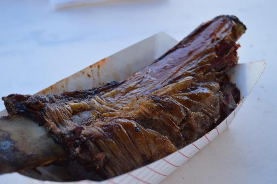 A massive beef rib placed in front of the author.