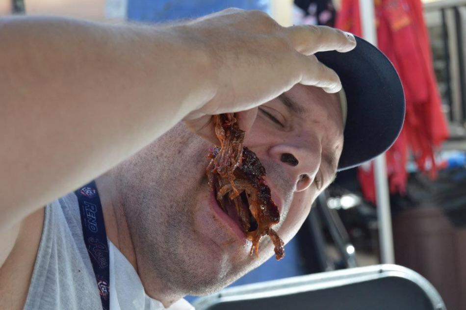 Reporter Brett Fisher taking in some beef rib from Carson City Barbecue.