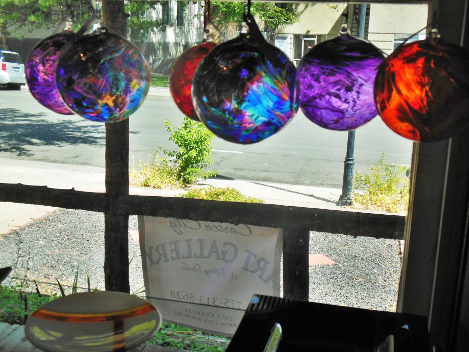 Glass ball ornaments hanging in the front room gallery.