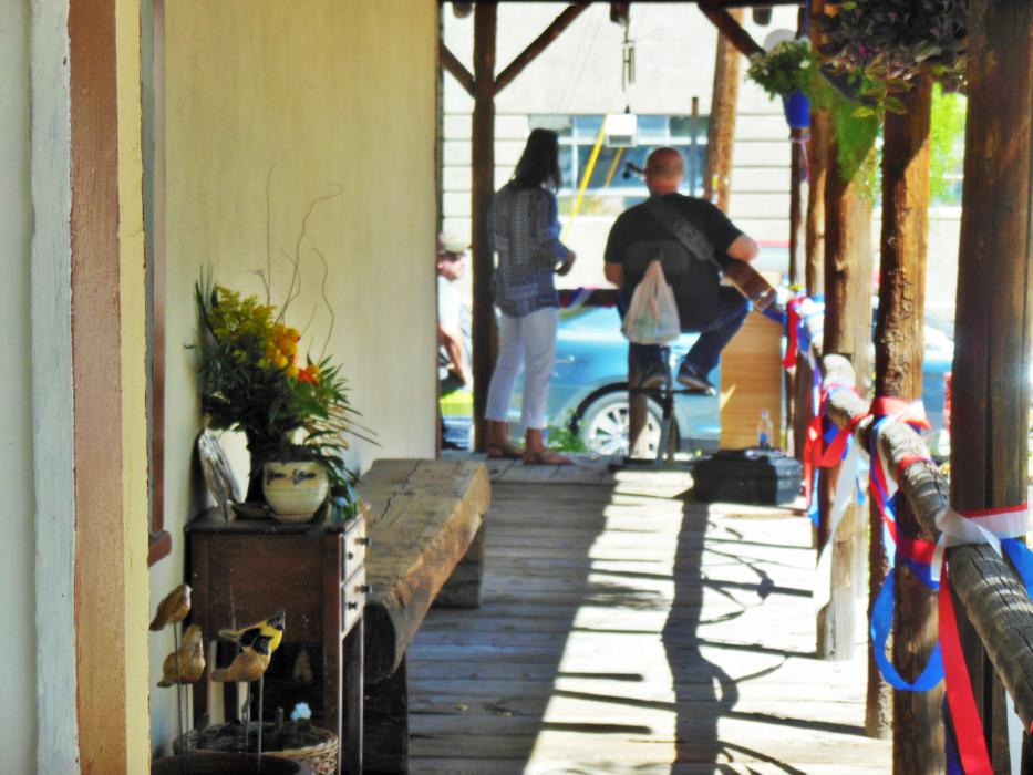 The covered front porch of the historic building located at 110 S. Curry Street.
