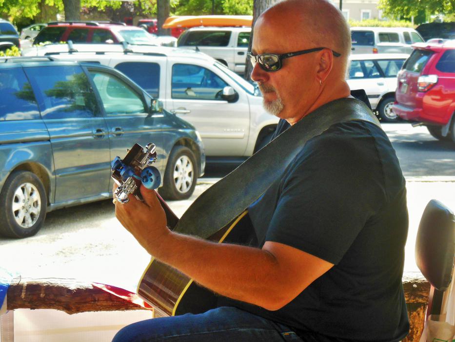 Everett Musselman on guitar Saturday during the grand opening of Carson City Art Gallery and Pottery Studio.