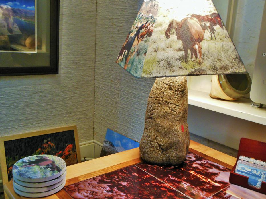 Lamp with a stone base and shade with wild horses design.