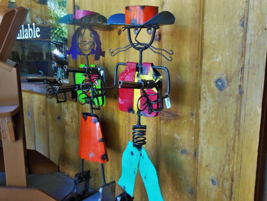 Cowboy and cowgirl metal figurines at the front entry to Touched By Angels.