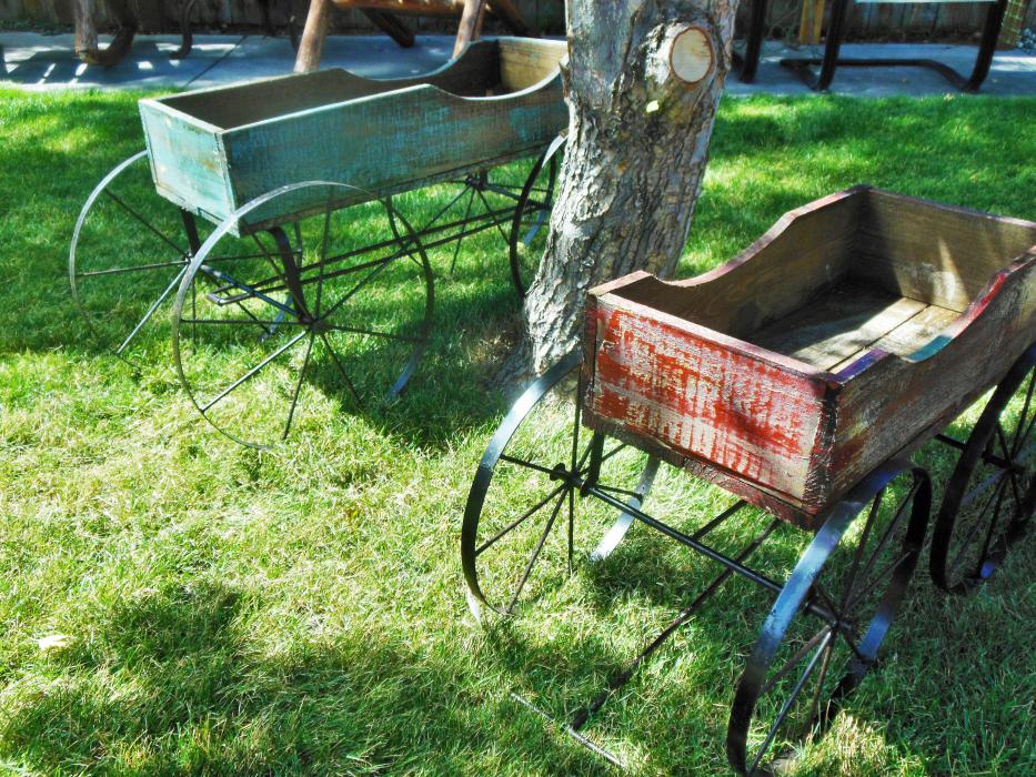 Miniature wagons displayed on front lawn.