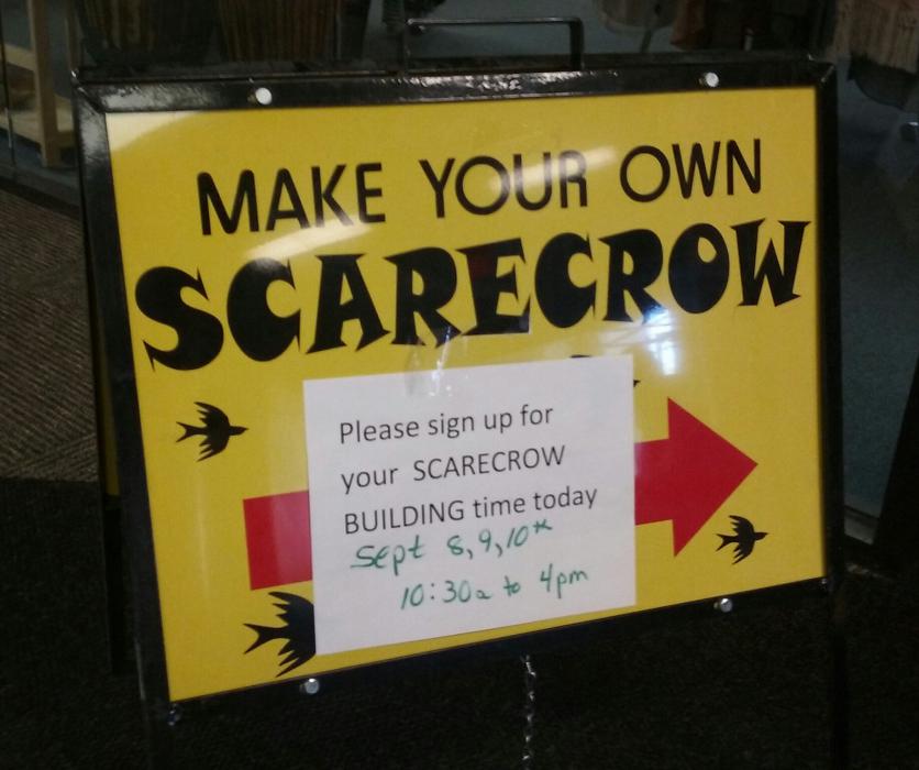 Scarecrow sign directing people inside Bridger Mountain Boutique.