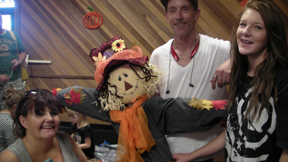 Getting the scarecrow ready are Serena Dillard, David Allen and Hanna Dillard.